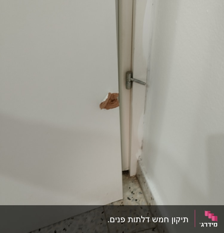 דלת לבנה עם חור קטן ליד הציר